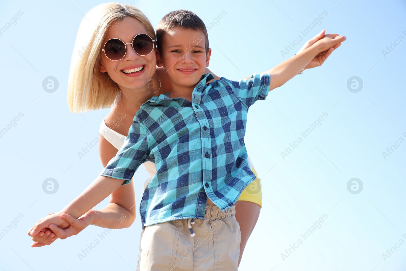Photo of Mother and son outdoors on sunny summer day. Family vacation