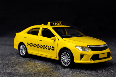 Yellow taxi car model on grey background