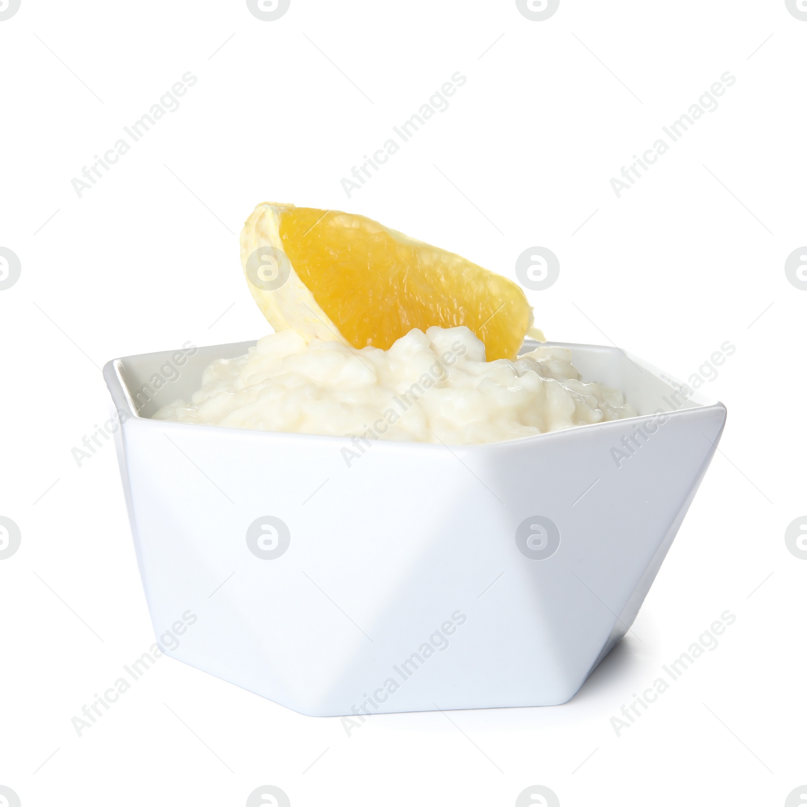 Photo of Creamy rice pudding with orange slice in bowl on white background