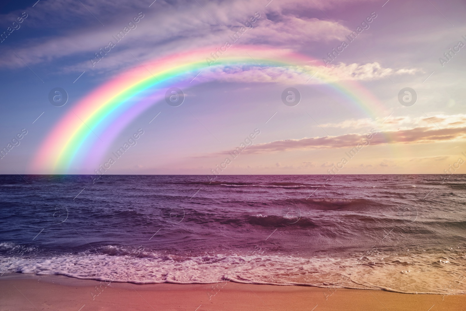 Image of Beautiful view of colorful rainbow in sky over sea