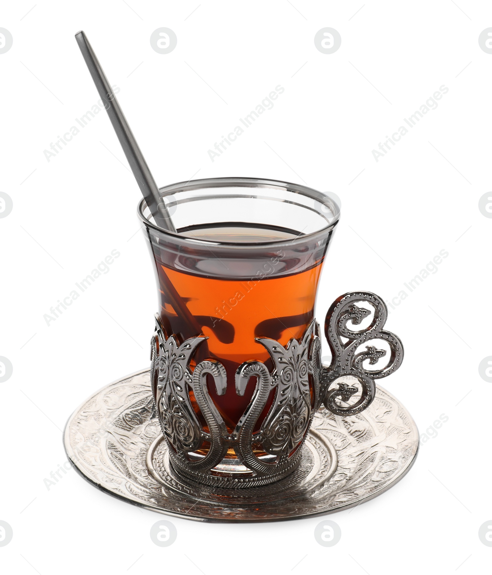 Photo of Glass of traditional Turkish tea in vintage holder isolated on white