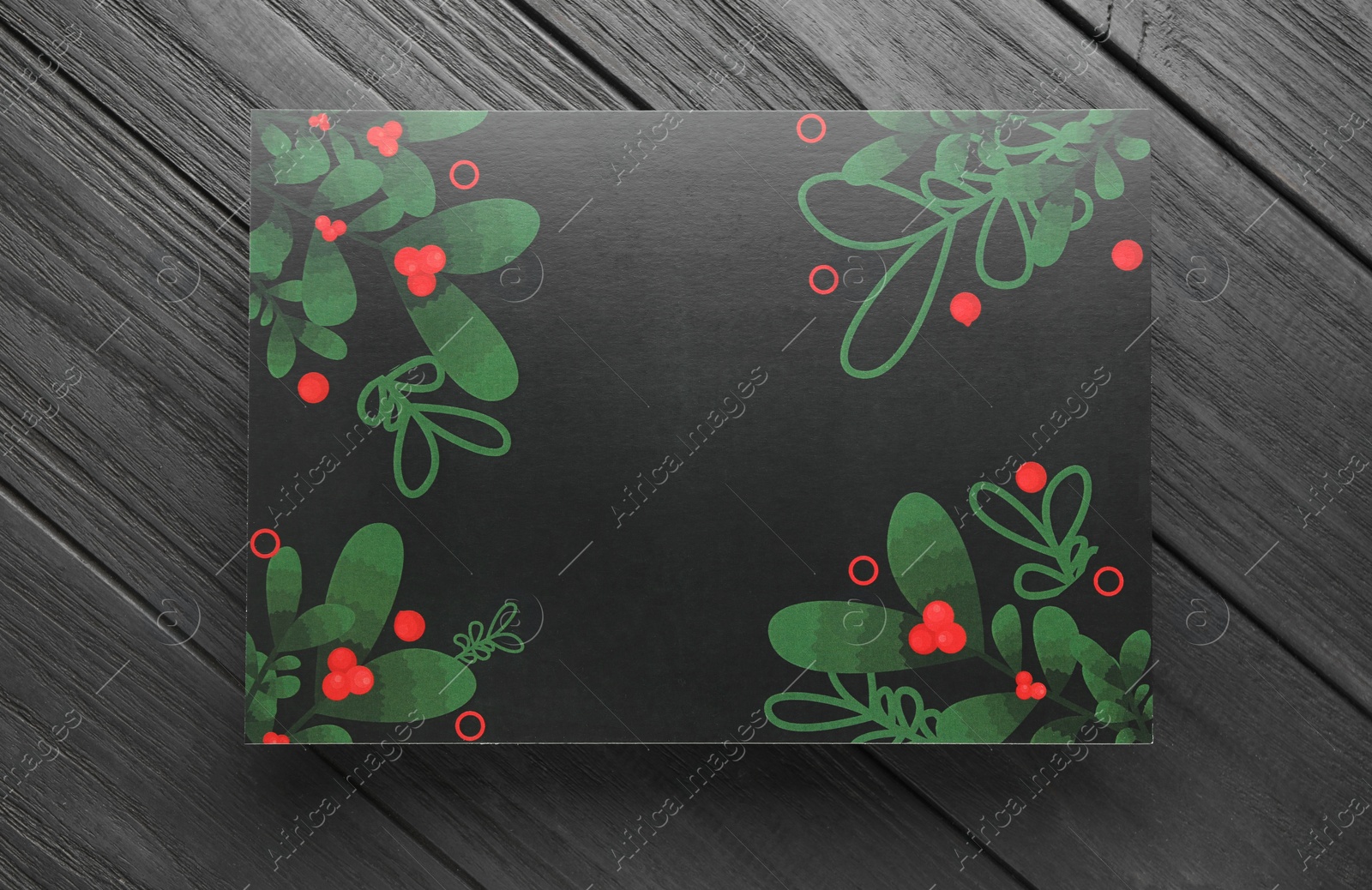 Photo of Blank Christmas invitation card on black wooden table, top view