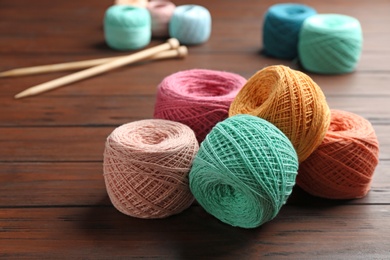 Colorful clews of threads on wooden table