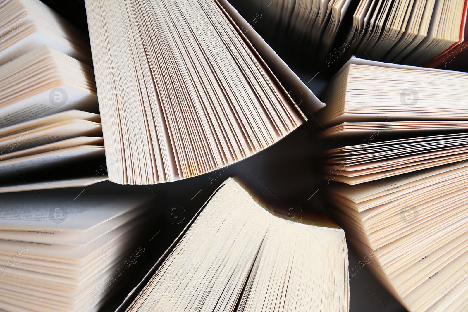 Photo of Collection of different books on white shelf, above view