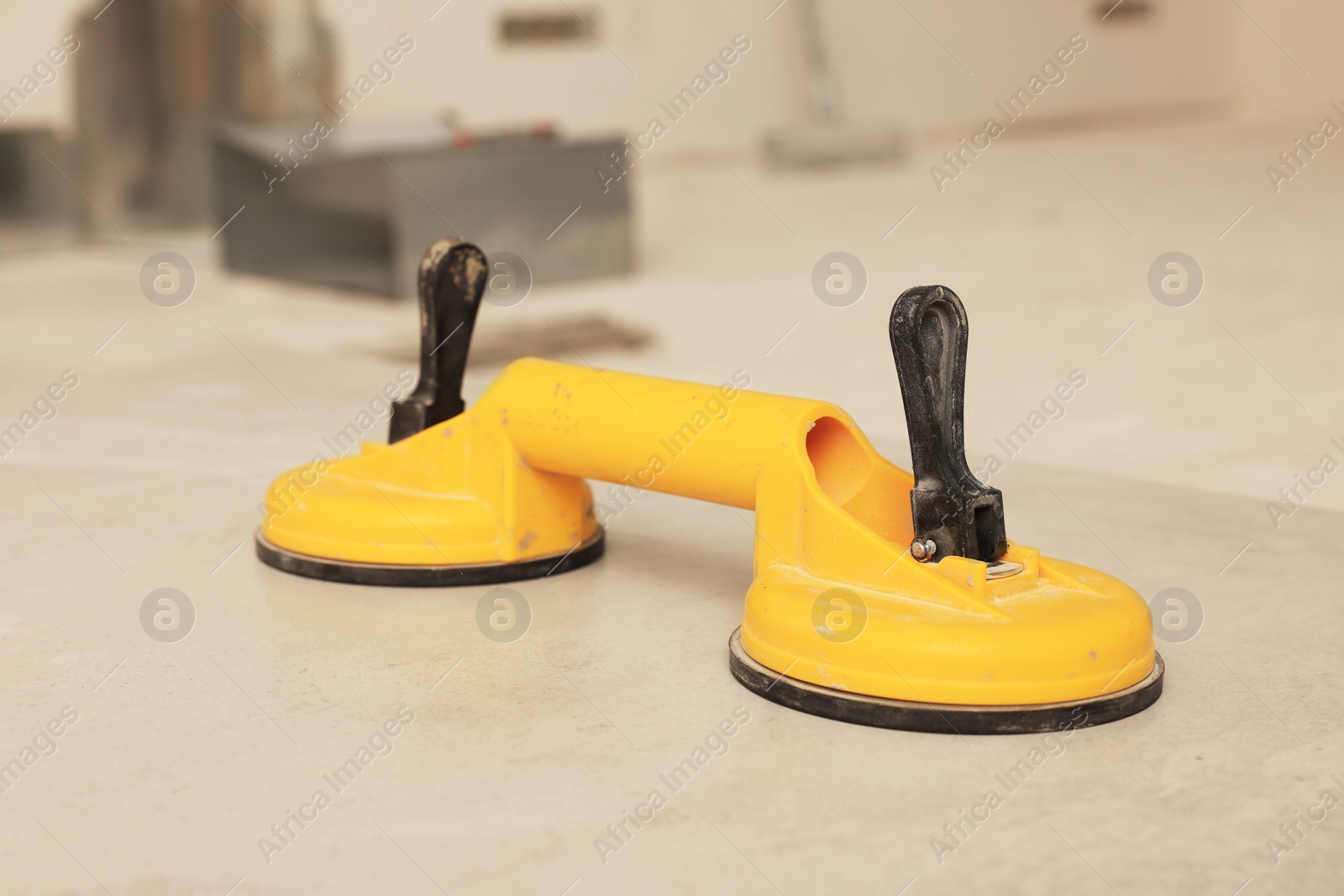 Photo of Yellow suction plate on tile indoors, closeup