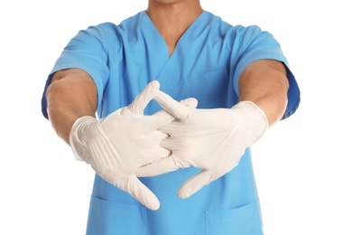 Photo of Male doctor in uniform wearing gloves on white background, closeup. Medical object
