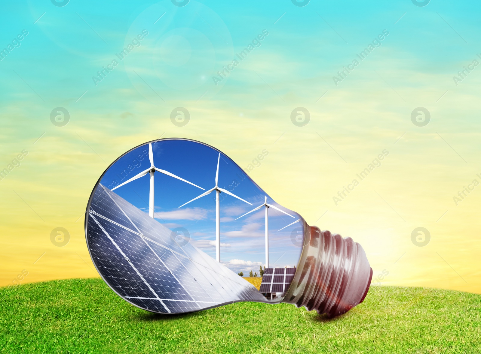 Image of Alternative energy source. Light bulb with solar panels and wind turbines outdoors