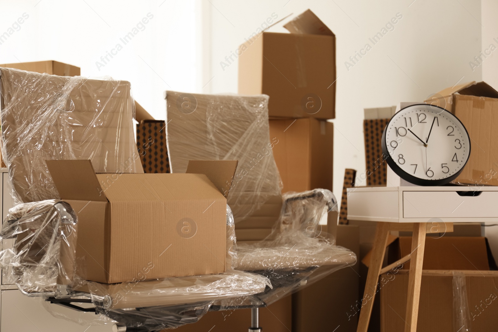 Photo of Packed stuff and cardboard boxes in office. Moving day