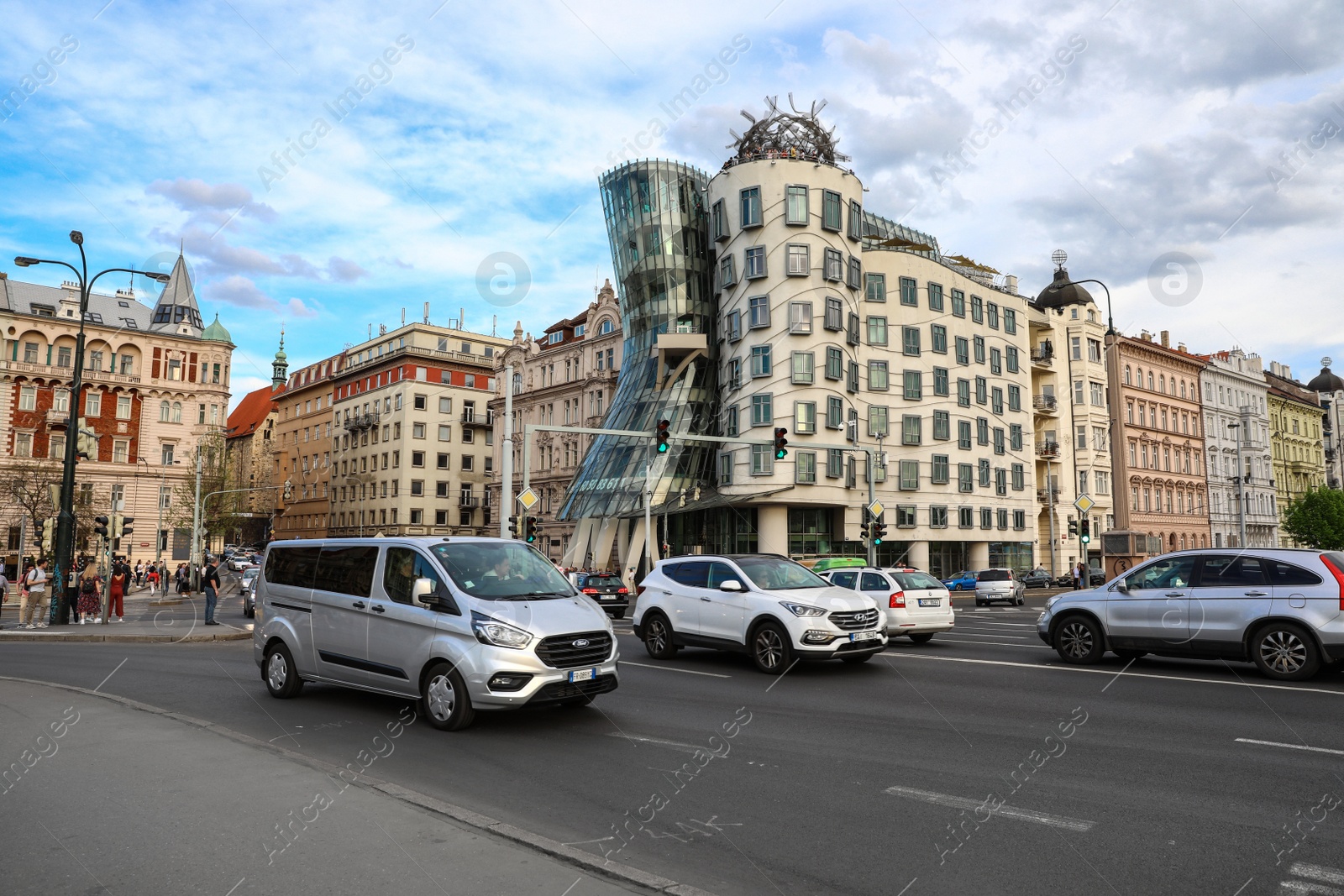 Photo of PRAGUE, CZECH REPUBLIC - APRIL 25, 2019: View of city street with road traffic near Dancing House