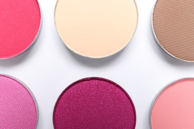 Photo of Beautiful eye shadow refill pans on white background, flat lay