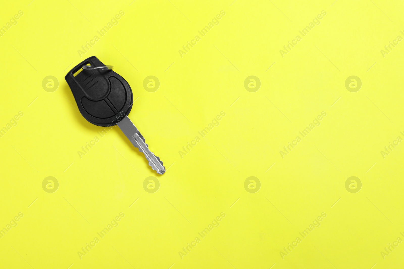 Photo of Car key on color background, top view with space for text