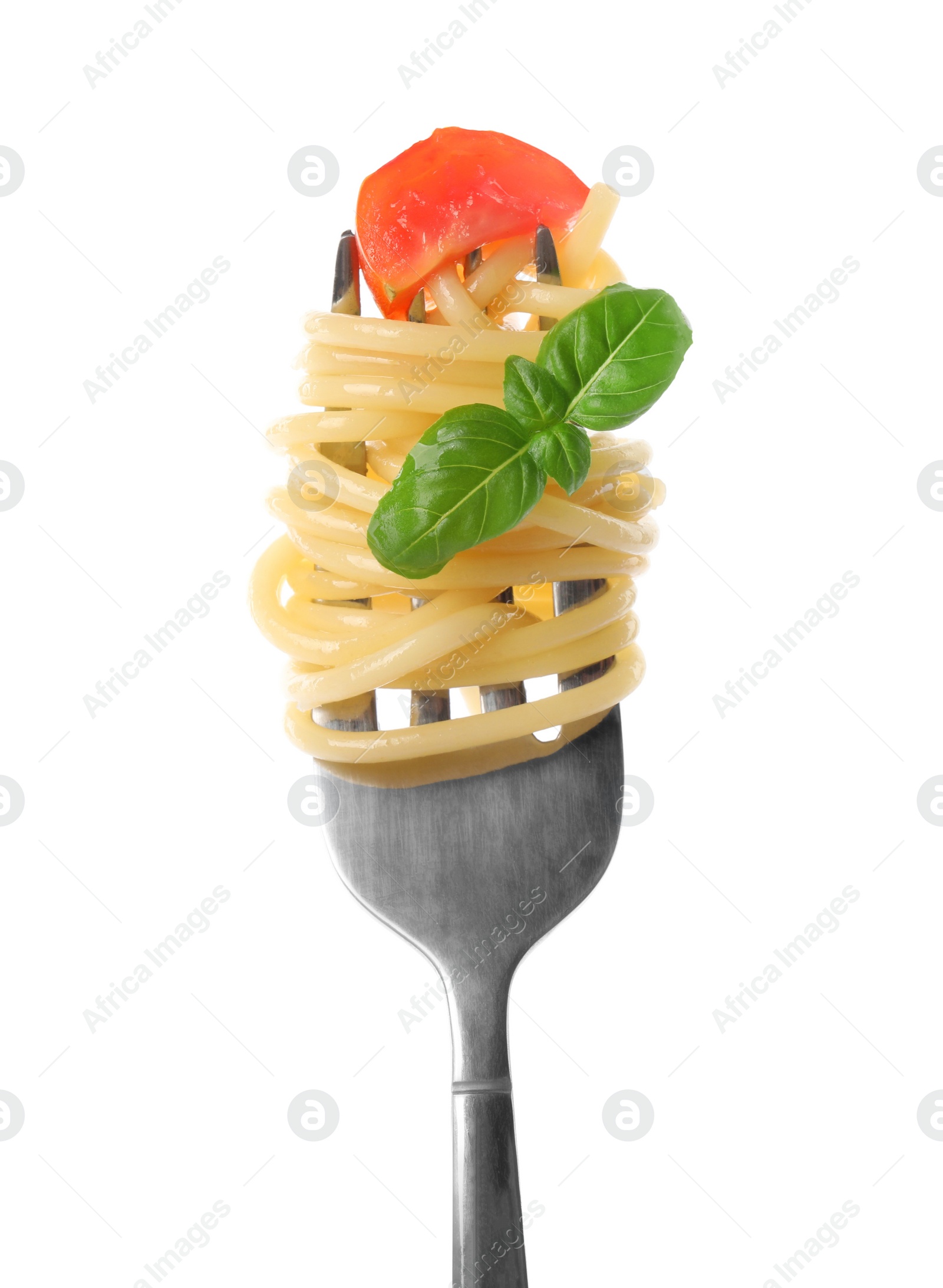 Photo of Fork with tasty pasta, piece of fresh tomato and basil isolated on white