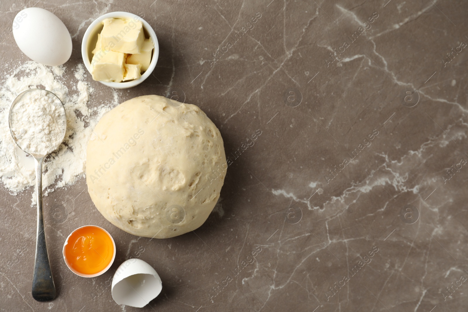 Photo of Flat lay composition with dough on marble table, space for text. Cooking pastries