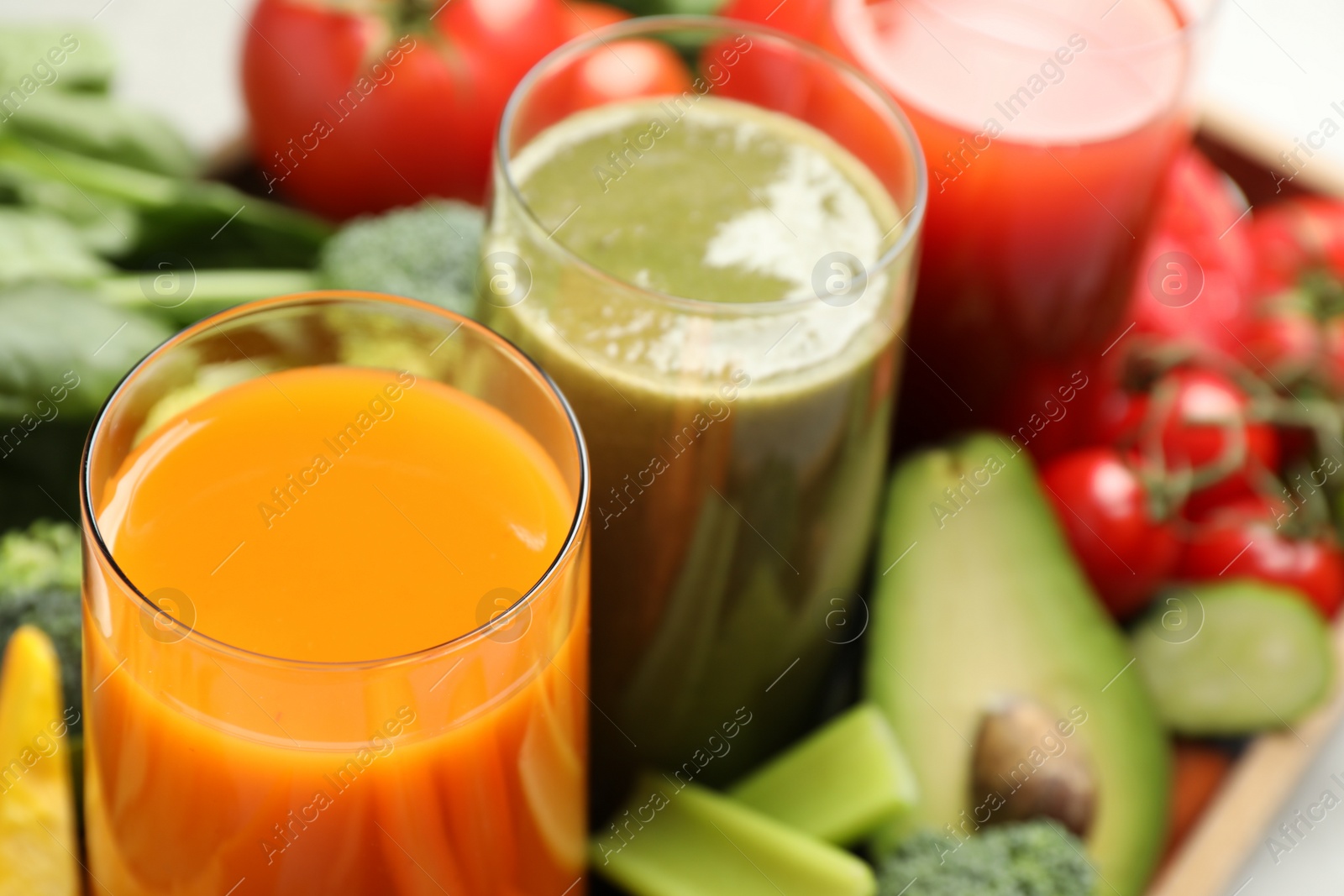 Photo of Delicious vegetable juices and fresh ingredients as background, closeup