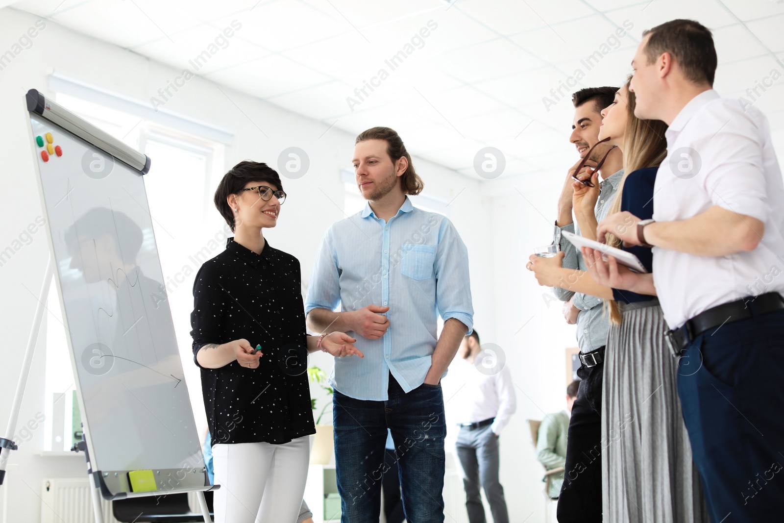 Photo of Young people having business training in office