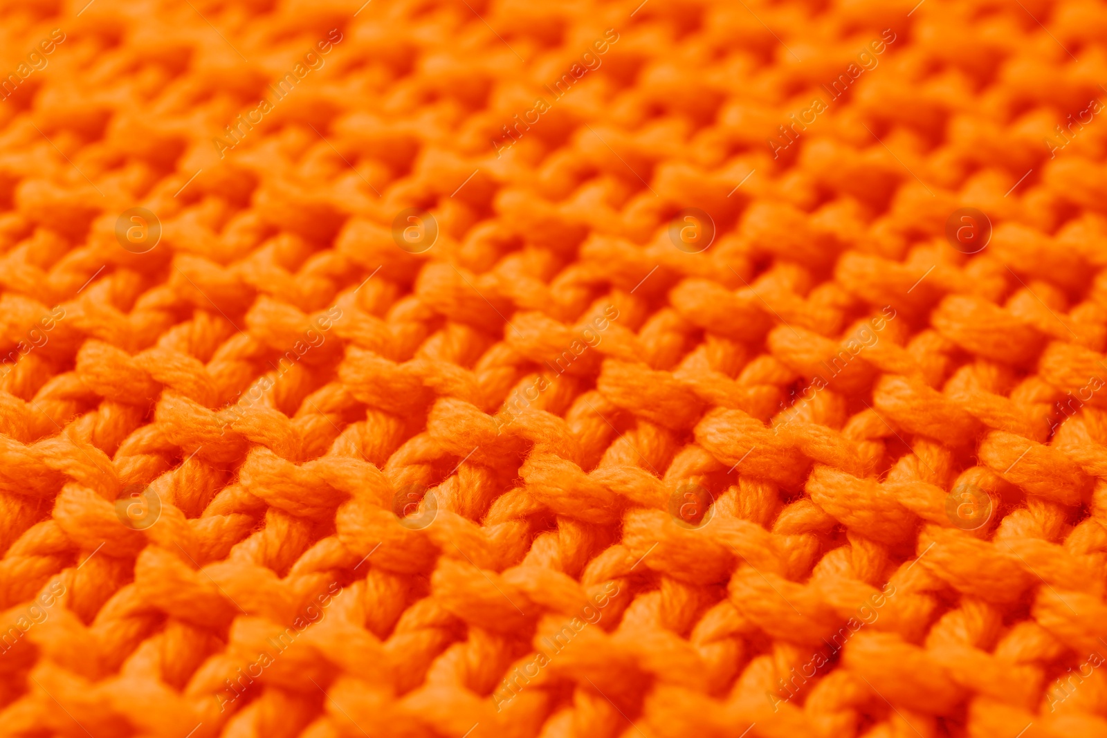 Image of Beautiful orange knitted fabric as background, closeup