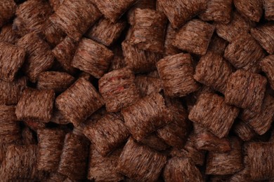 Tasty chocolate cereal pads as background, top view