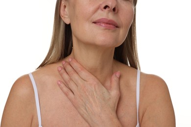 Photo of Mature woman touching her neck on white background, closeup