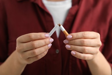 Photo of Stop smoking concept. Woman breaking cigarette, closeup