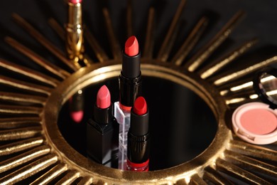 Beautiful red and pink lipsticks on mirror