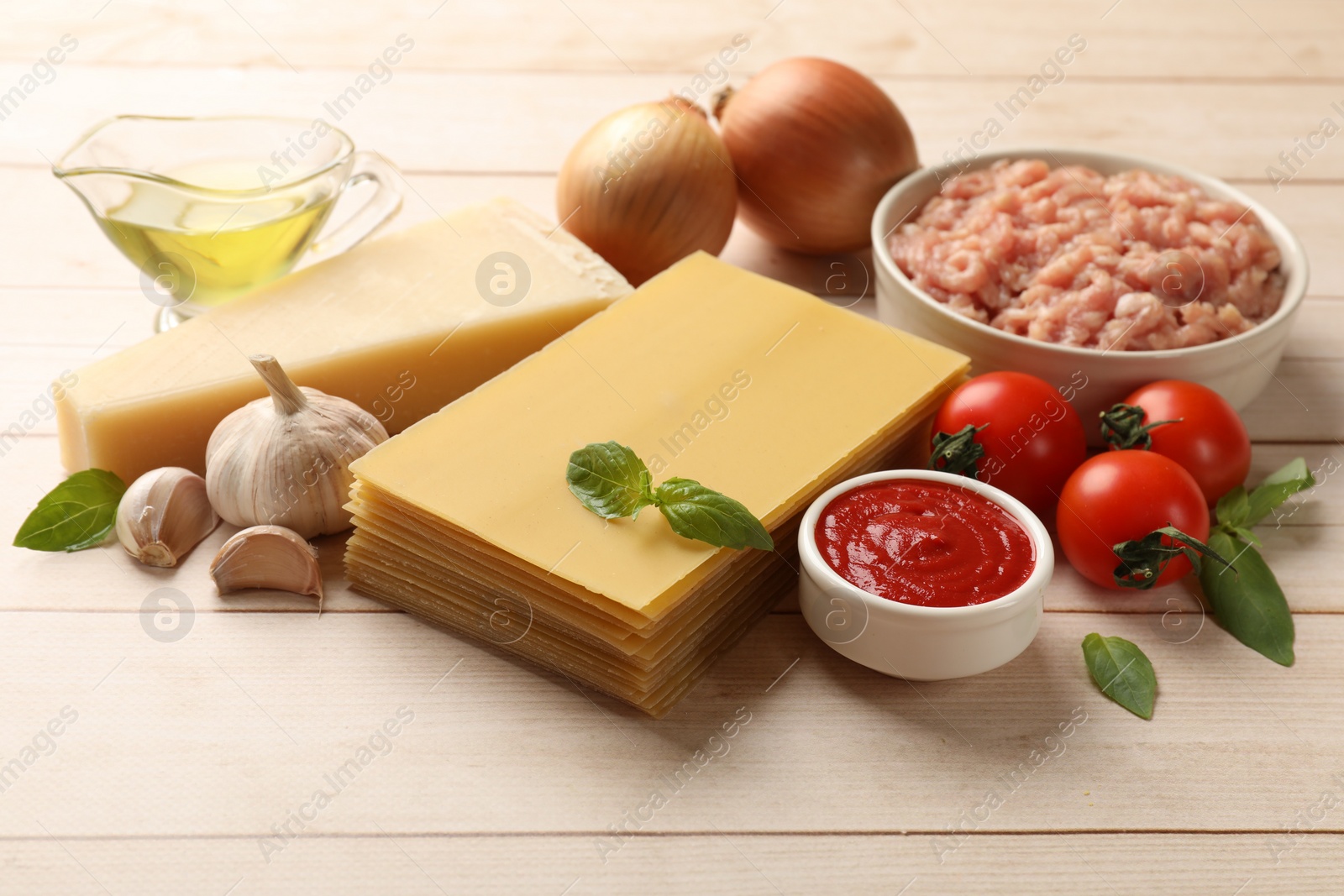 Photo of Ingredients for lasagna on white wooden table
