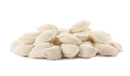 Photo of Heap of raw dumplings on white background