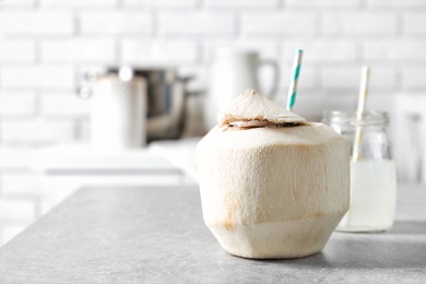 Fresh coconut drink in nut on kitchen table