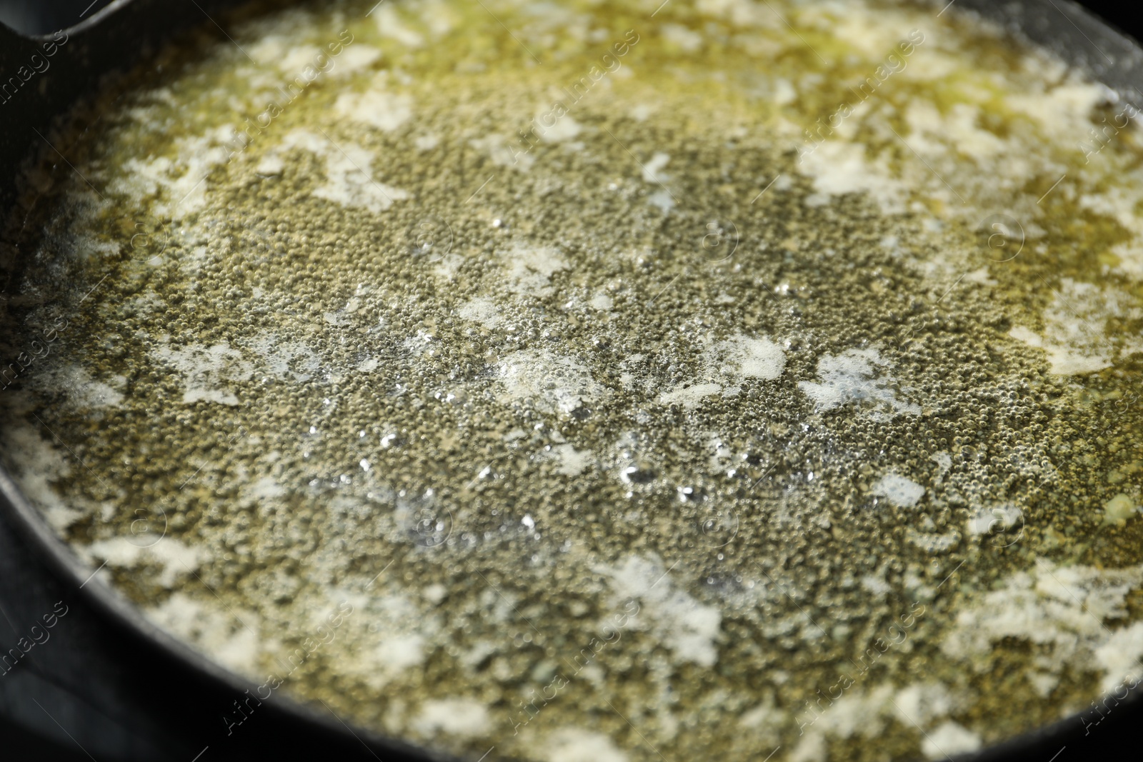 Photo of Melted butter in frying pan, closeup view