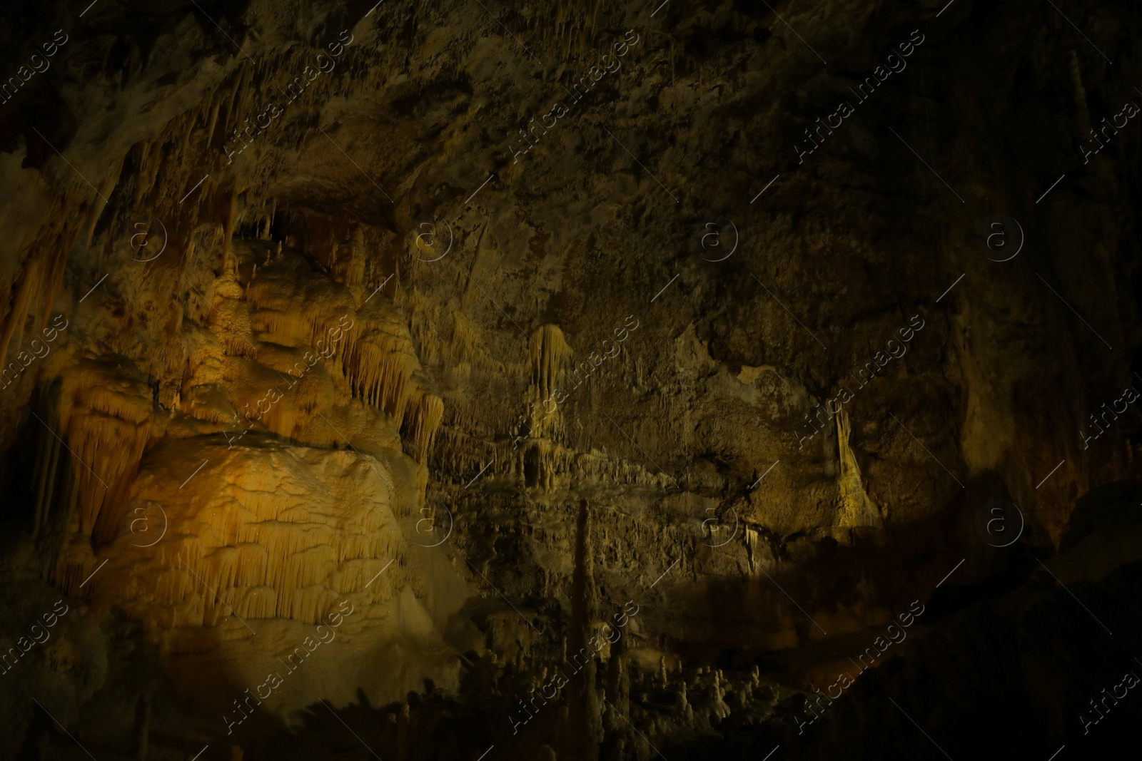 Photo of Many stalactite and stalagmite formations inside cave