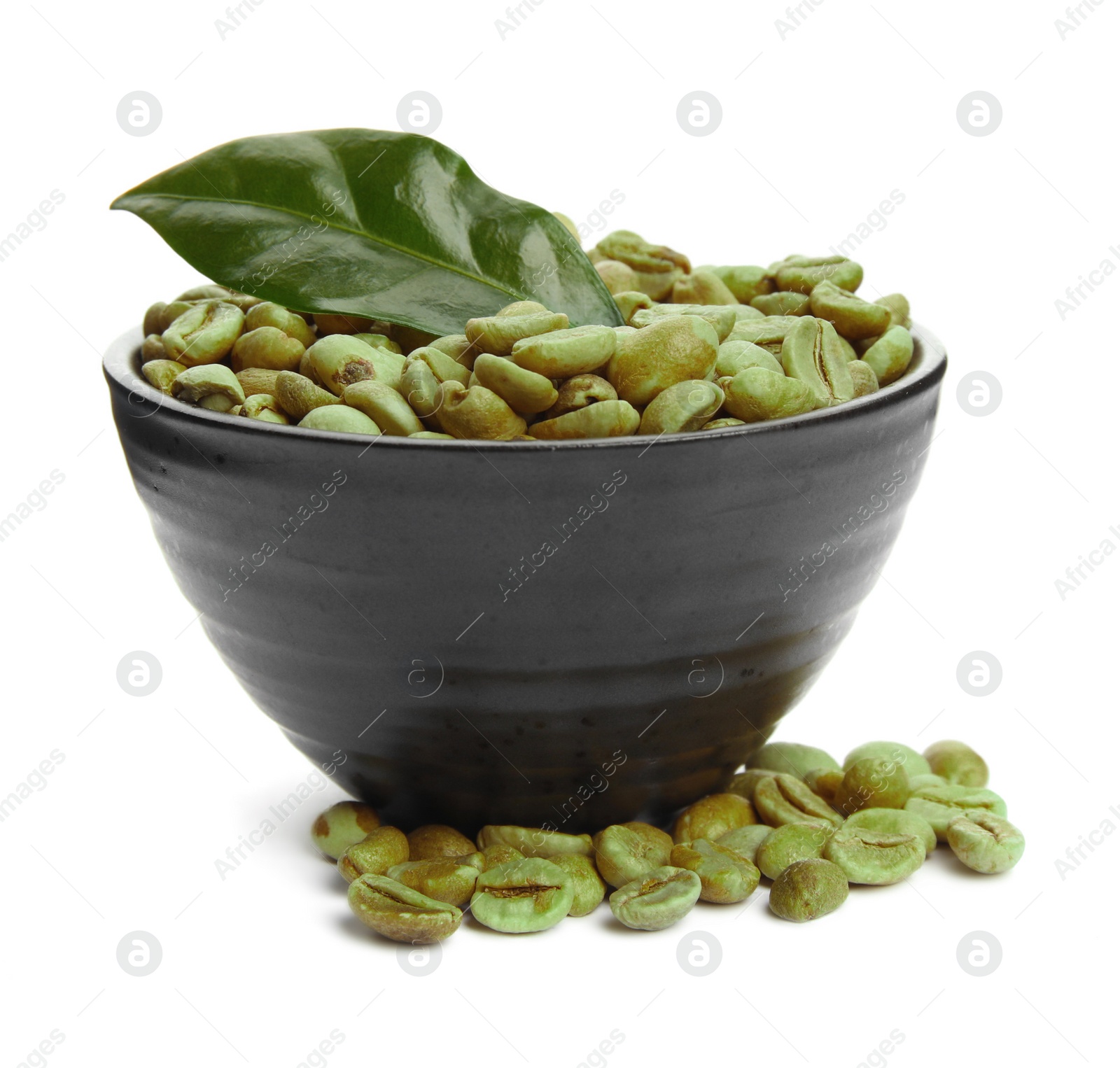 Photo of Bowl with green coffee beans and fresh leaf on white background