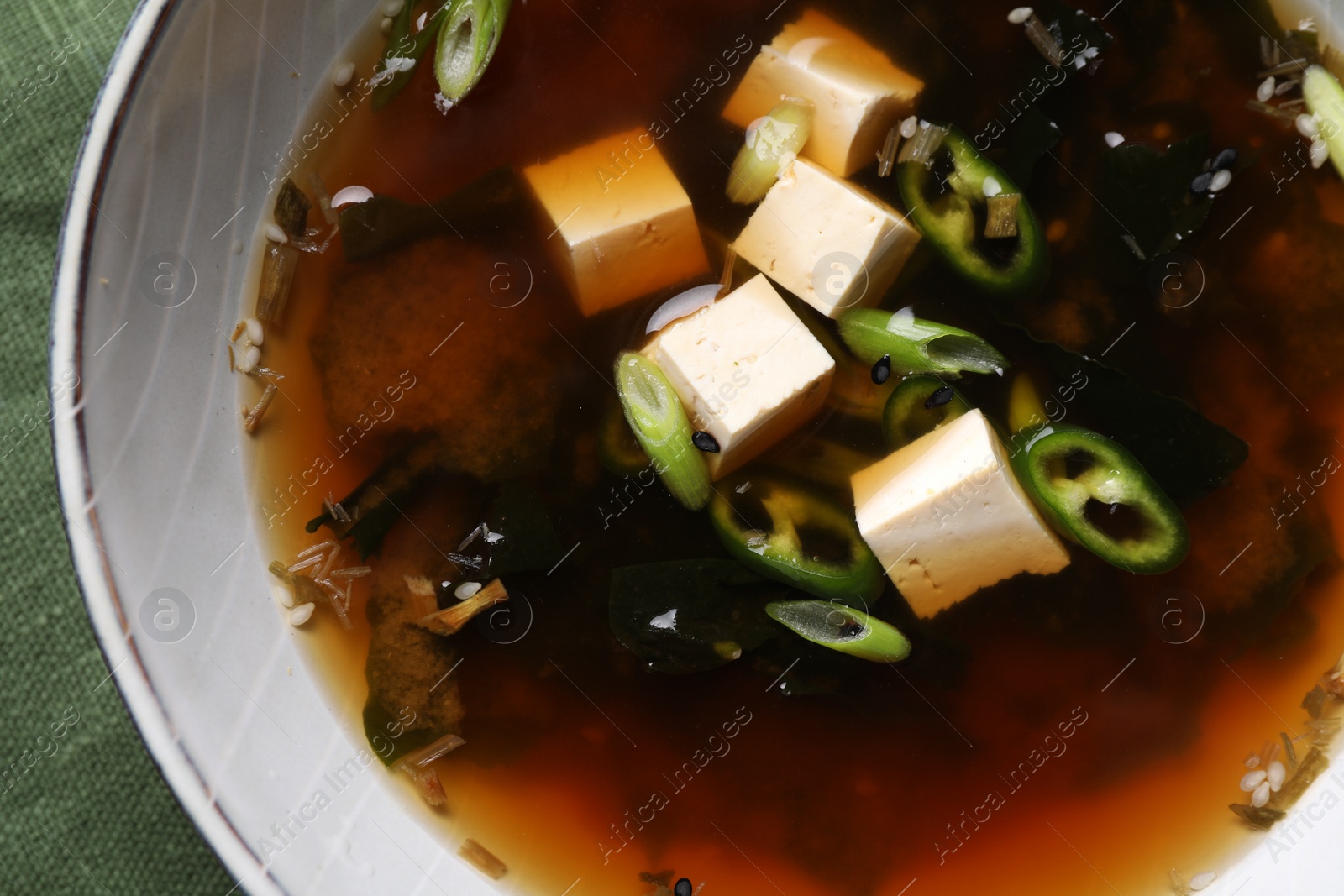 Photo of Bowl of delicious miso soup with tofu, top view