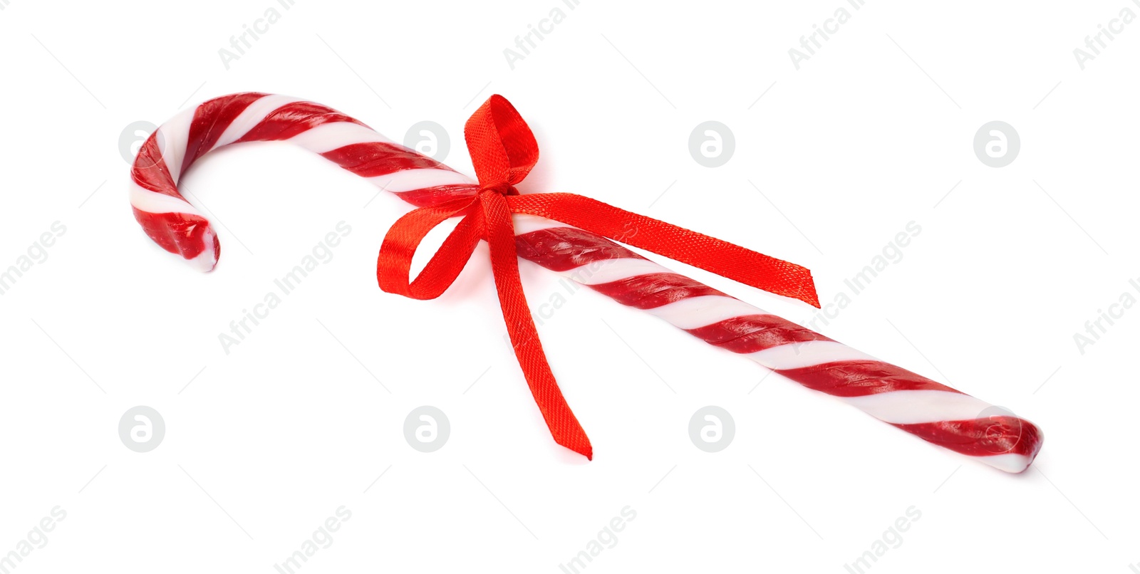 Photo of Delicious Christmas candy cane with red bow isolated on white