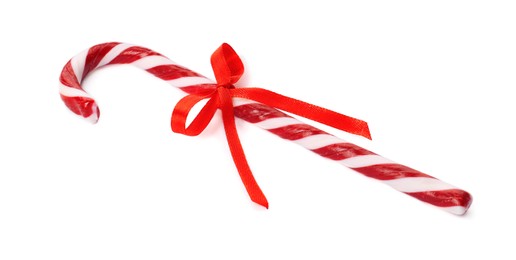 Photo of Delicious Christmas candy cane with red bow isolated on white