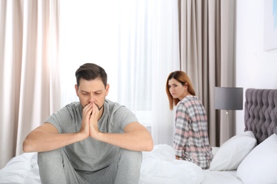 Photo of Couple with relationship problems ignoring each other in bedroom