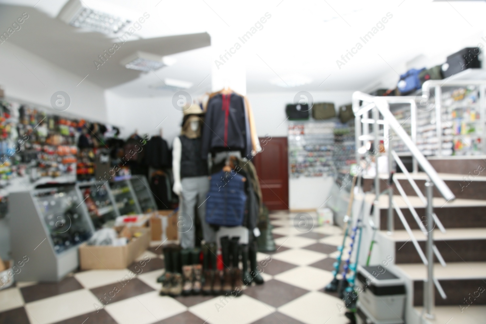 Photo of Blurred view of sports shop with fishing equipment and clothing