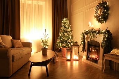 Photo of Beautiful room interior with fireplace and Christmas decor in evening