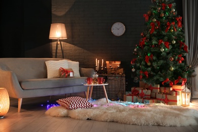 Photo of Stylish room interior with decorated Christmas tree