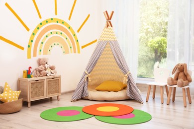 Cute child's room interior with beautiful sun painted on wall