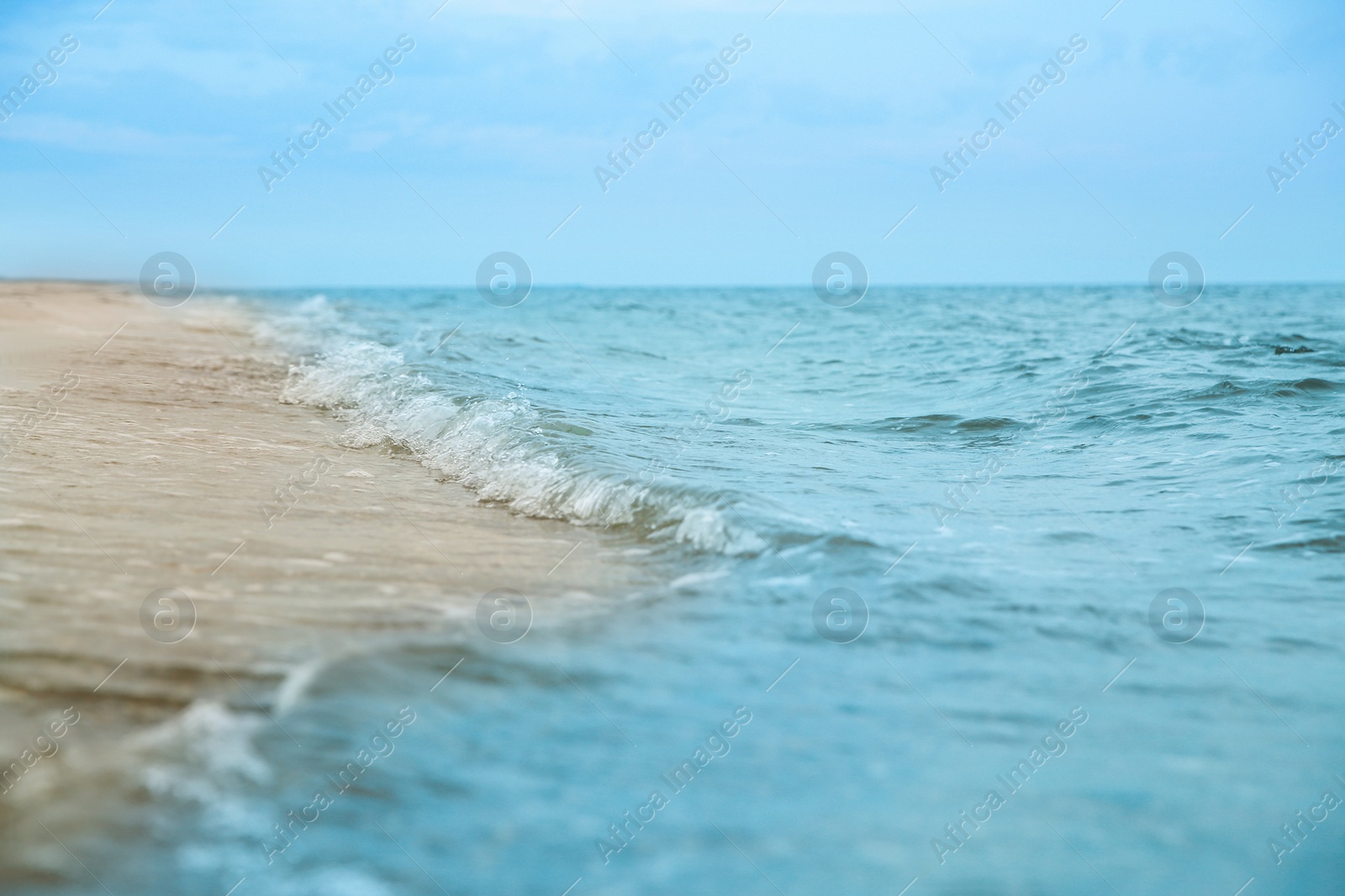Photo of Beautiful view of sea tide on sandy beach. Summer vacation
