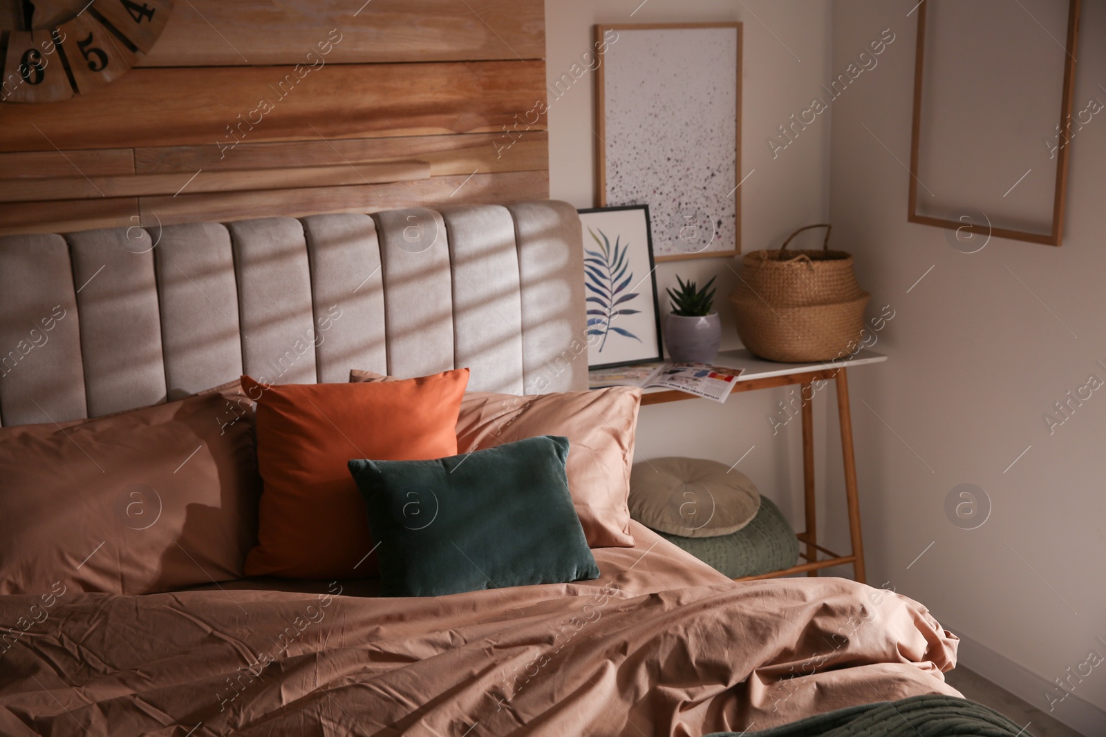 Photo of Bed with stylish linen and soft pillows in room