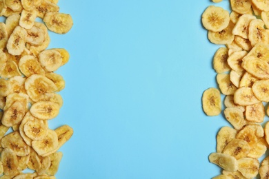 Frame made of sweet banana slices on color  background, top view with space for text. Dried fruit as healthy snack