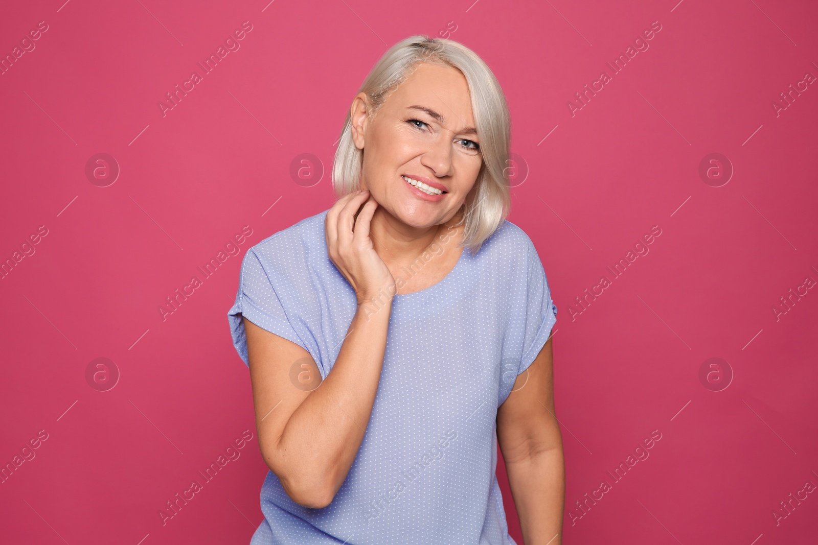 Photo of Mature woman scratching neck on color background. Annoying itch