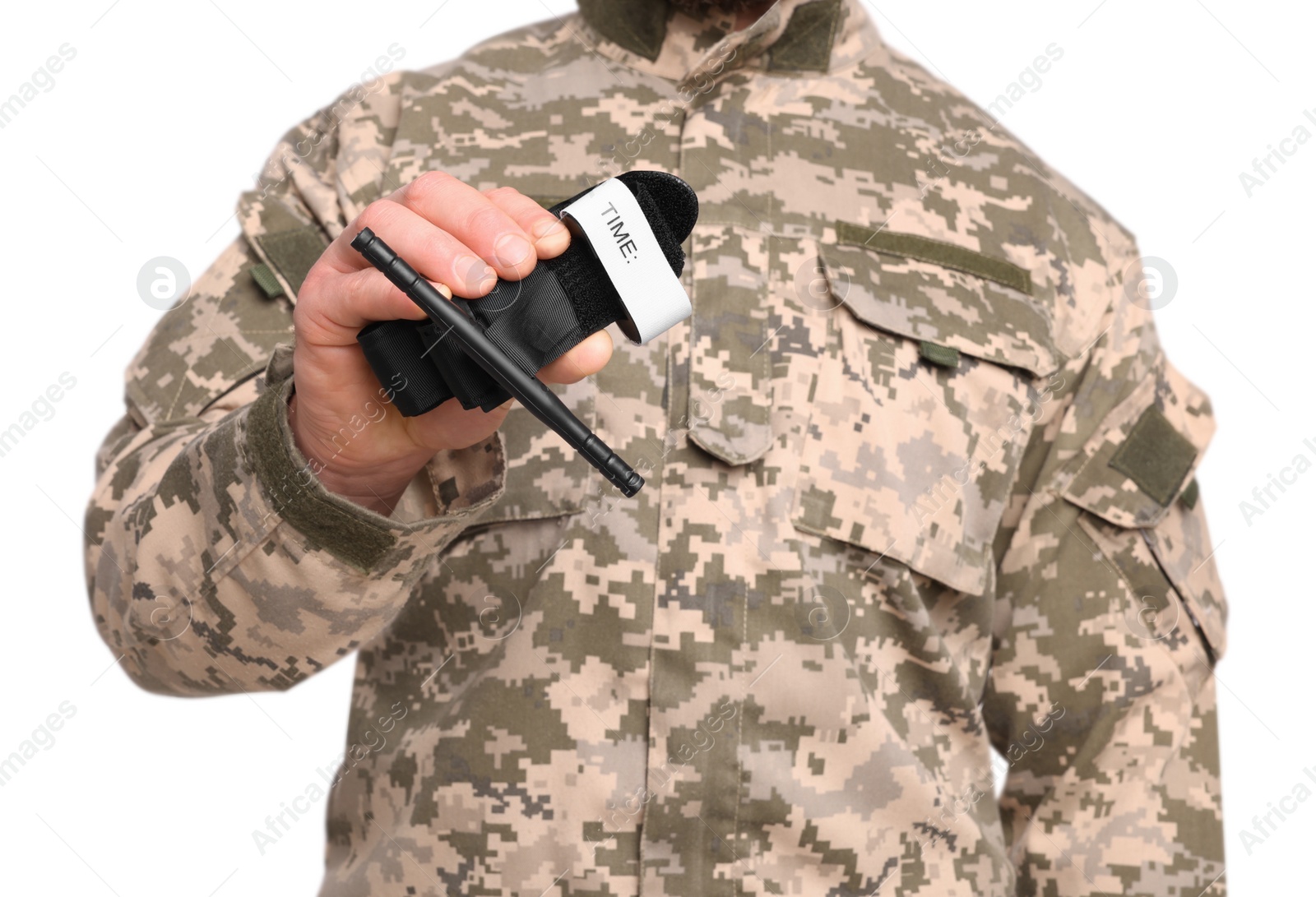 Photo of Soldier in military uniform holding medical tourniquet on white background, closeup