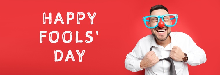 Joyful man with funny glasses on red background, banner design. Happy fool's day