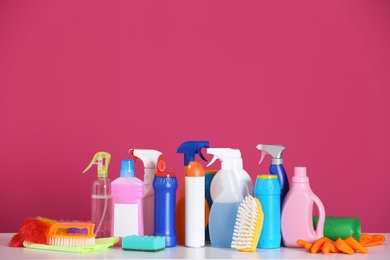 Cleaning supplies on color background