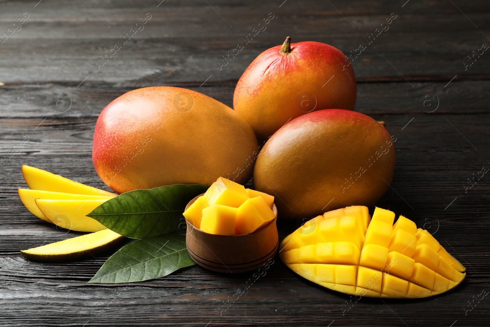 Photo of Composition with fresh mango on wooden background