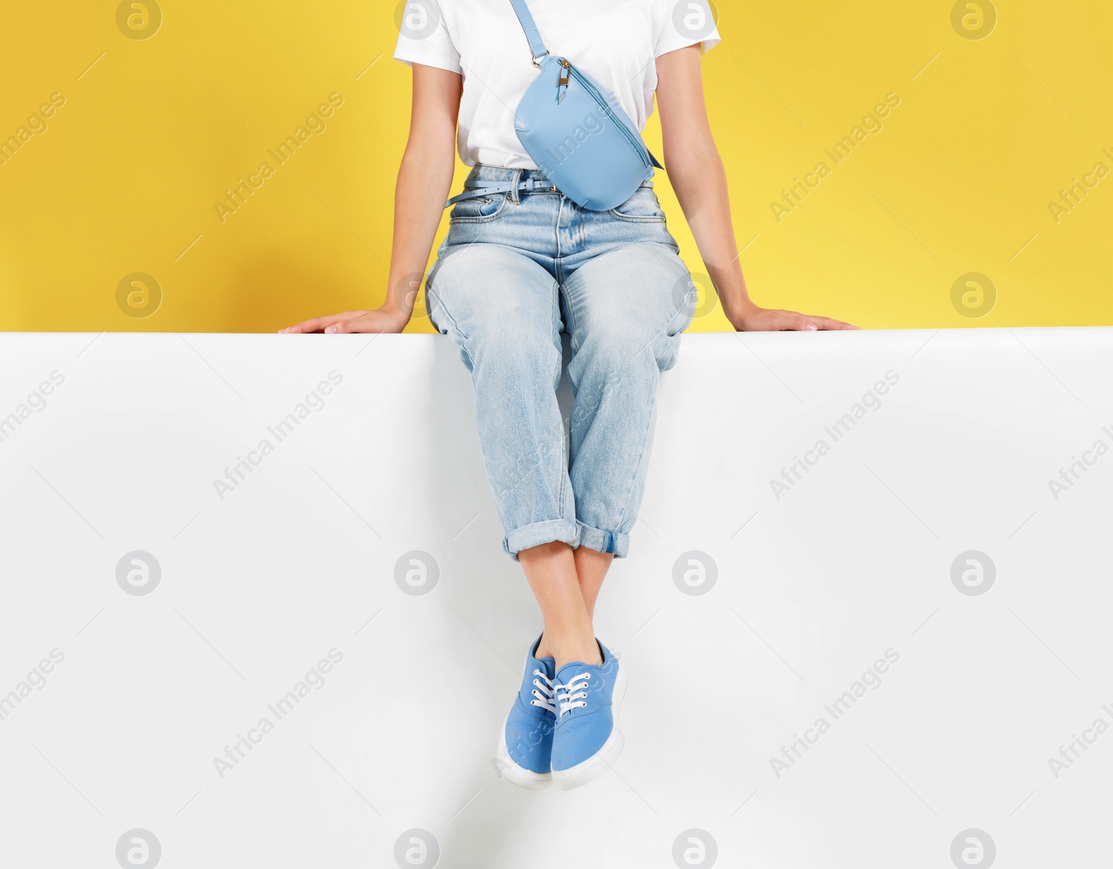 Photo of Woman wearing stylish shoes on color background, closeup