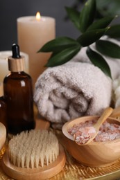 Photo of Spa composition. Pink sea salt, brush and bottle, closeup