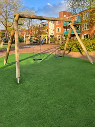 Photo of Outdoor wooden swings at backyard on sunny day