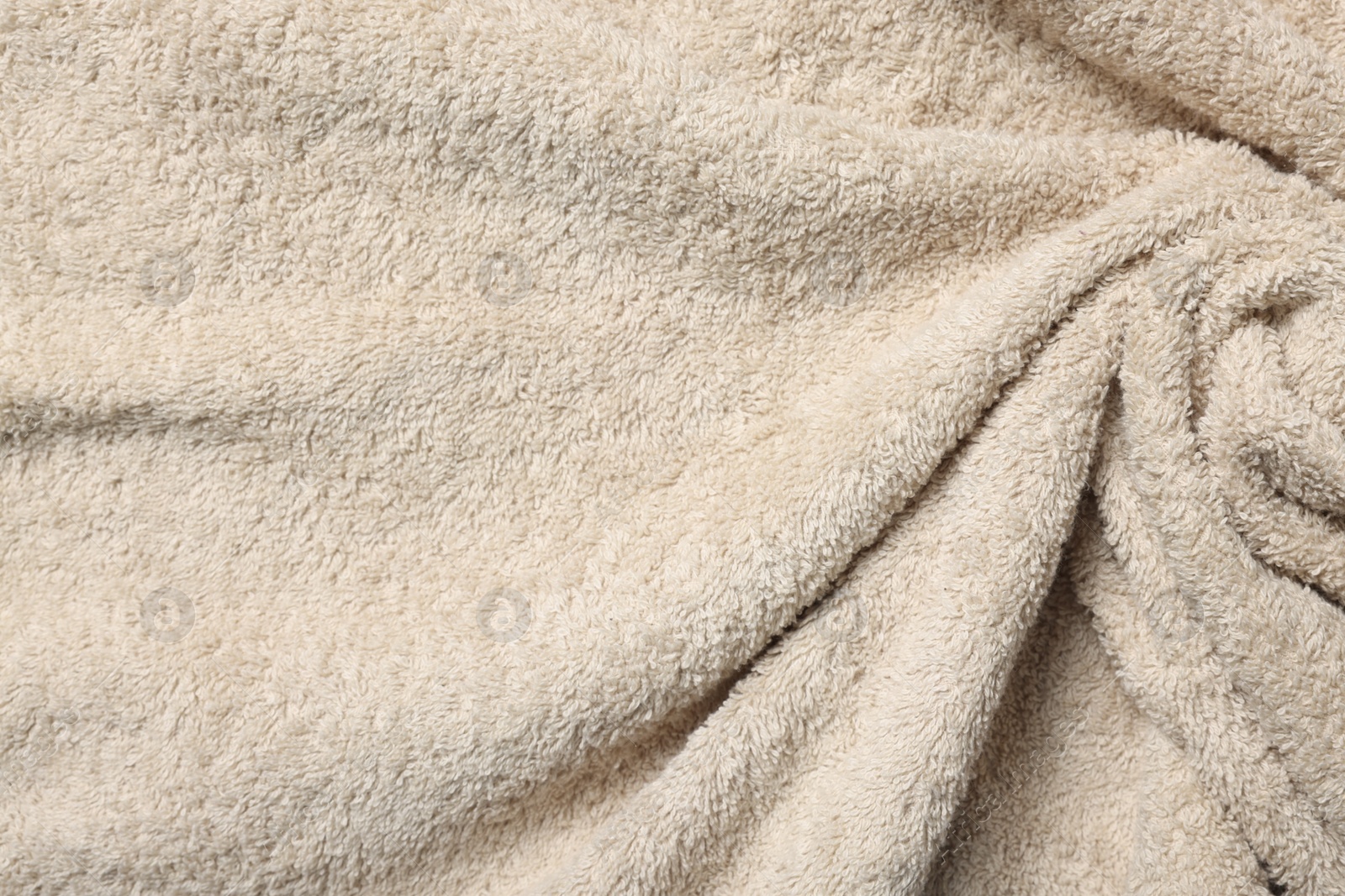 Photo of Texture of beige crumpled fabric as background, top view